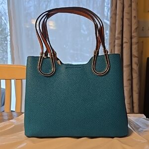 Classic Blue Shoulder Bag with Tan Leather Like Handles, Gold And Black Accents.